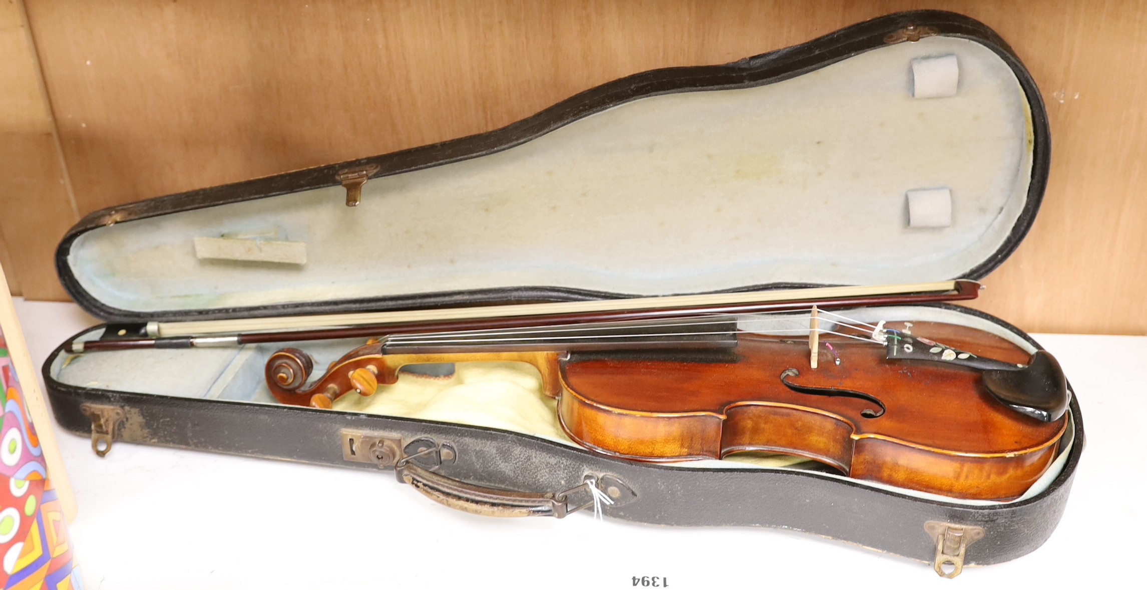 A French single back violin, interior label reads ‘Médio Fino’, back measures 35.5cm excl button. With case and bow